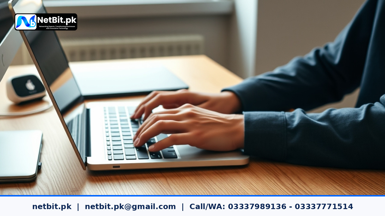 A software developer typing on a modern laptop inside a bright tech office environment. | NetBit Software House and Technology | netbit.pk